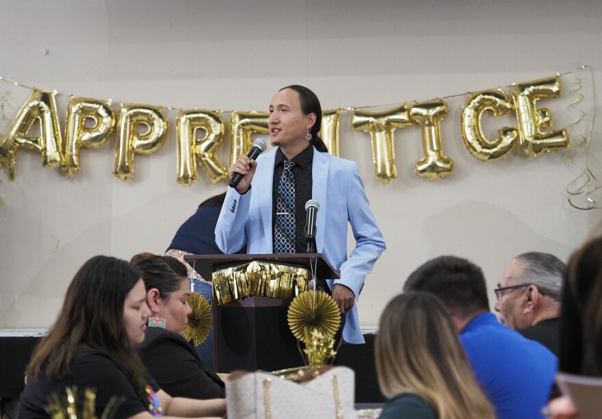 Willy Bass, manager of community impact for Ho-Chunk, Inc., speaks at the Winnebago Public Schools Apprenticeship Achievement Ceremony on May 15, 2024 in Sloan, Iowa.