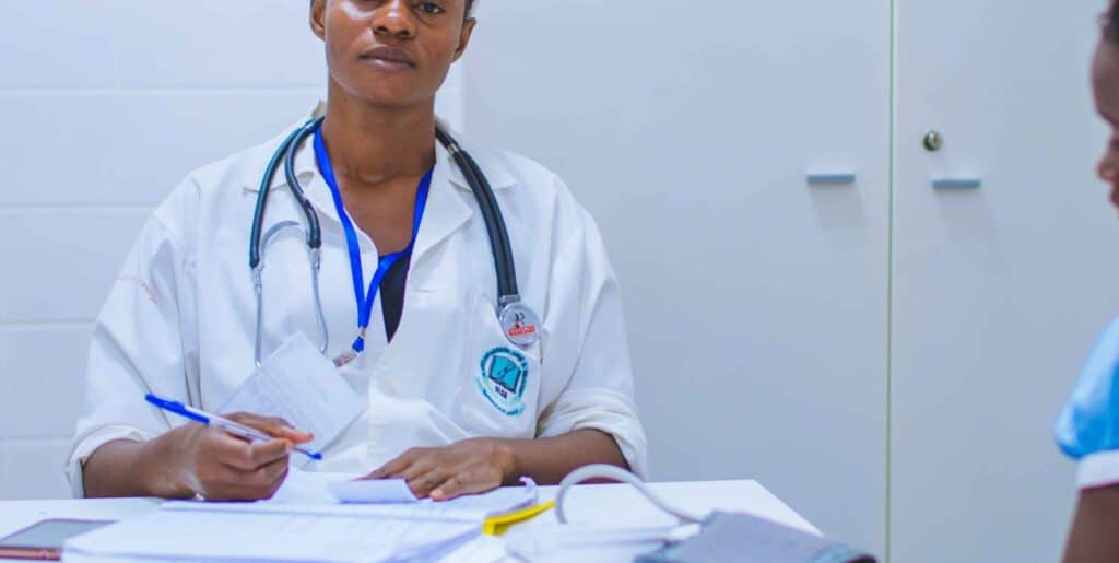 Older woman consulting with healthcare professional in a medical setting, emphasizing the impact of.