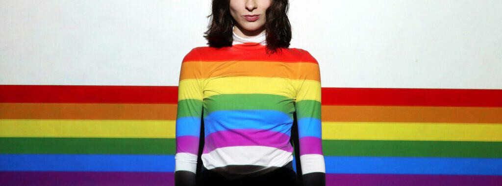Rainbow-colored clothing representing conscious consumerism and LGBTQ+ pride beyond rainbow-washing.