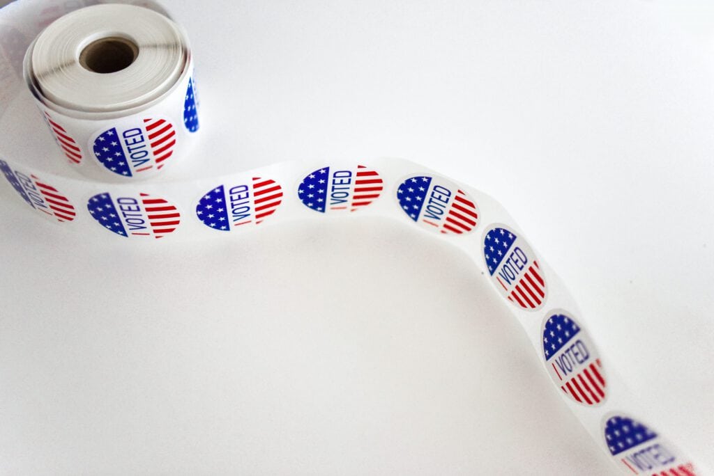 Voter ballot tape with "VOTED" stickers for upcoming judicial primary elections.