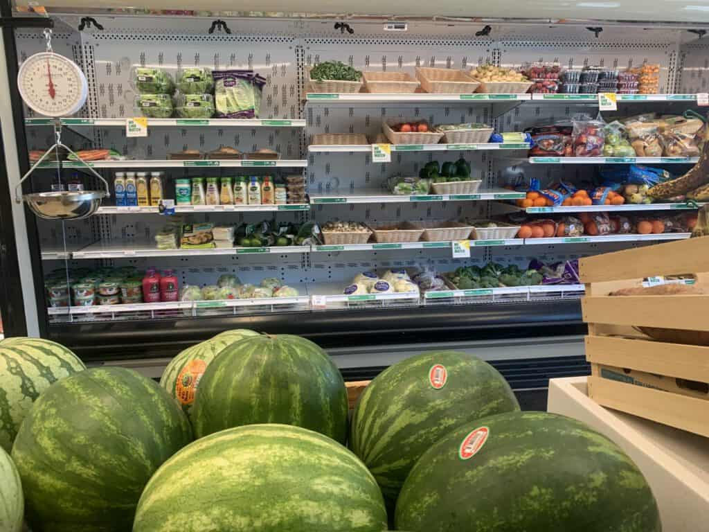 Fresh watermelons displayed at a local grocery store promoting food accessibility.