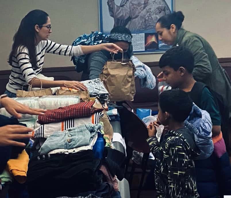 Venezuelan asylum seekers receiving aid at Chicago community center.