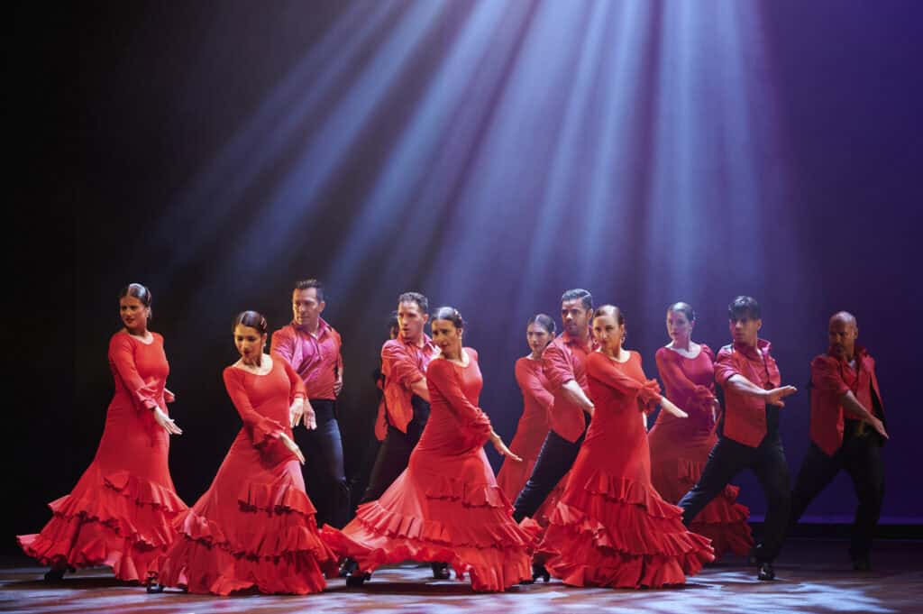Flamenco dancers performing on stage at North Shore Center during "Flamenco Passion" event.