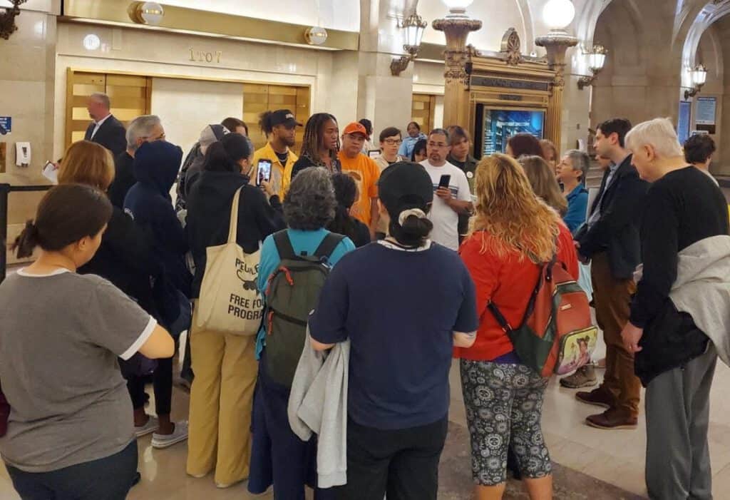Polluted communities face ongoing health challenges as residents gather in a public space.