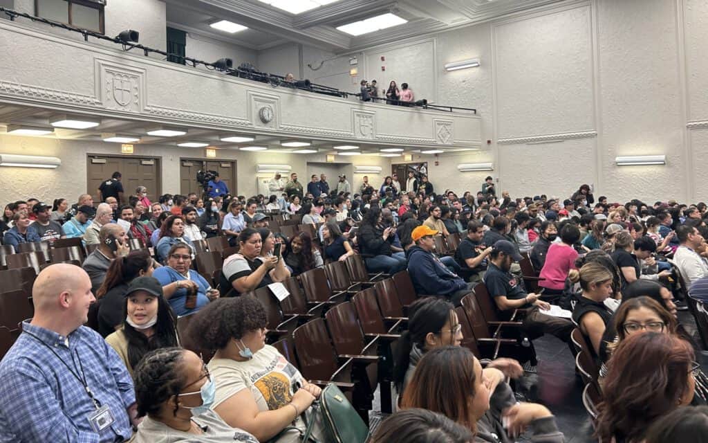 Community meeting in Brighton Park addressing migrant encampment concerns.