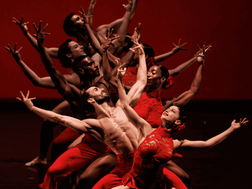 Ballet Hispánico dancers performing an inclusive cultural dance in vibrant red costumes.