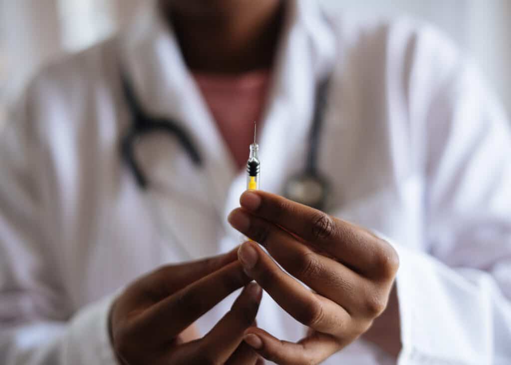 COVID-19 vaccine being prepared by healthcare professional.