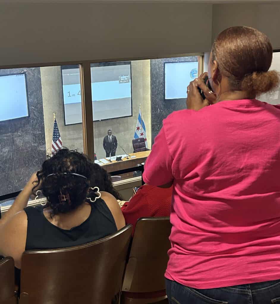 City council meeting on paid leave ordinance in Chicago with diverse attendees.