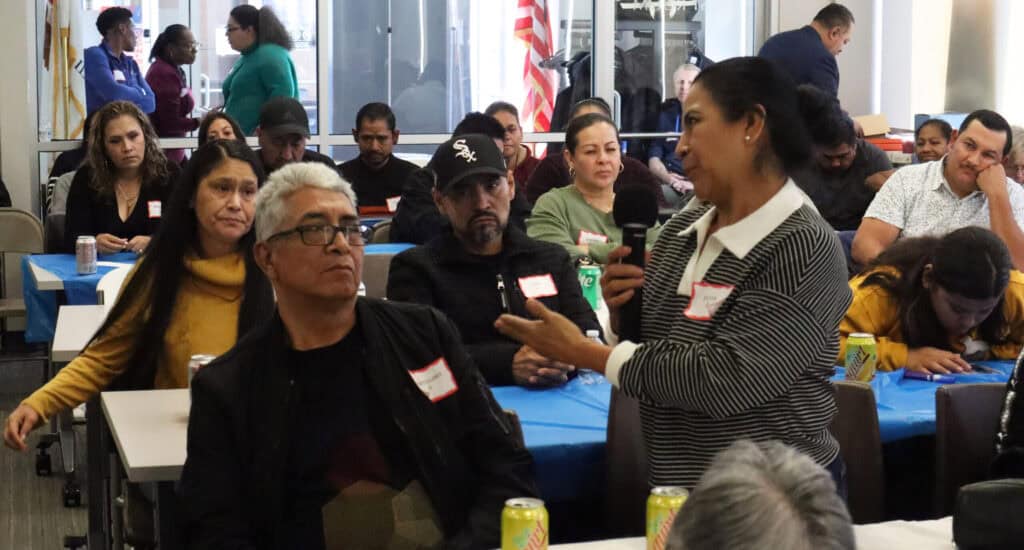 Latino community members sharing stories at a health awareness event.