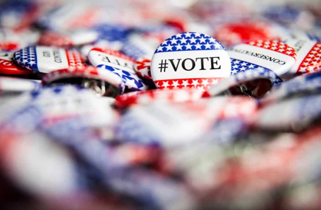 Voter buttons with patriotic red, white, and blue colors for election participation and civic engage.