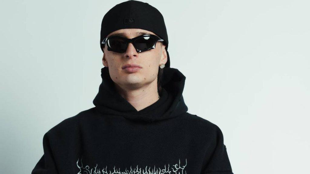 Peso Pluma, Mexican singer, wearing sunglasses and black hoodie, performs at a concert in Washington.