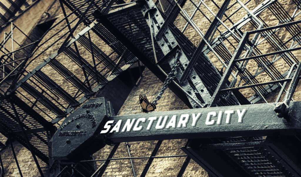View of the "Sanctuary City" sign on a building facade in Hartford.