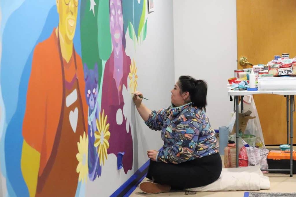 Colorful mural art by Latine artist brightens neighborhood walls in Western WA.