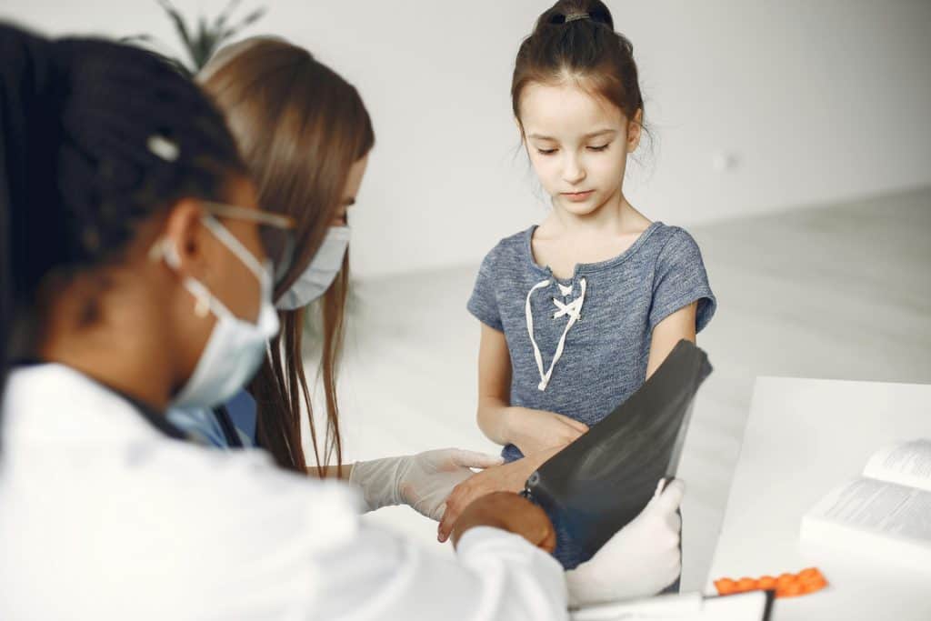 Latino children receiving health checkups to reduce disparities in Harris County.