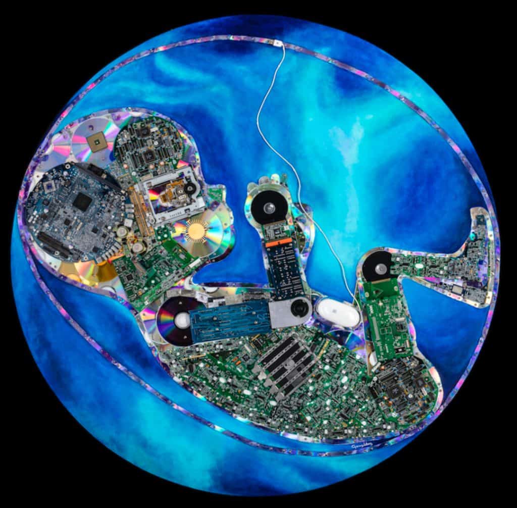 Artistic sculpture made from recycled electronic components on a blue background.