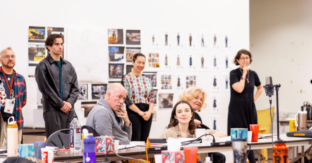 An image of actors and director during a rehearsal for "All My Sons," exploring themes of the Americ.