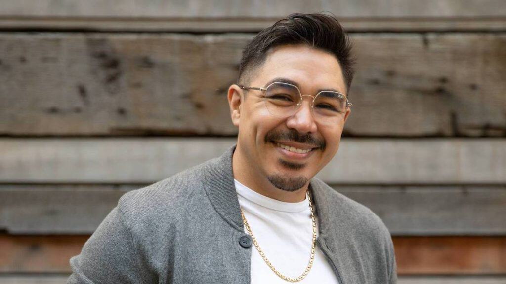 Portrait of a successful Latino poet smiling confidently.