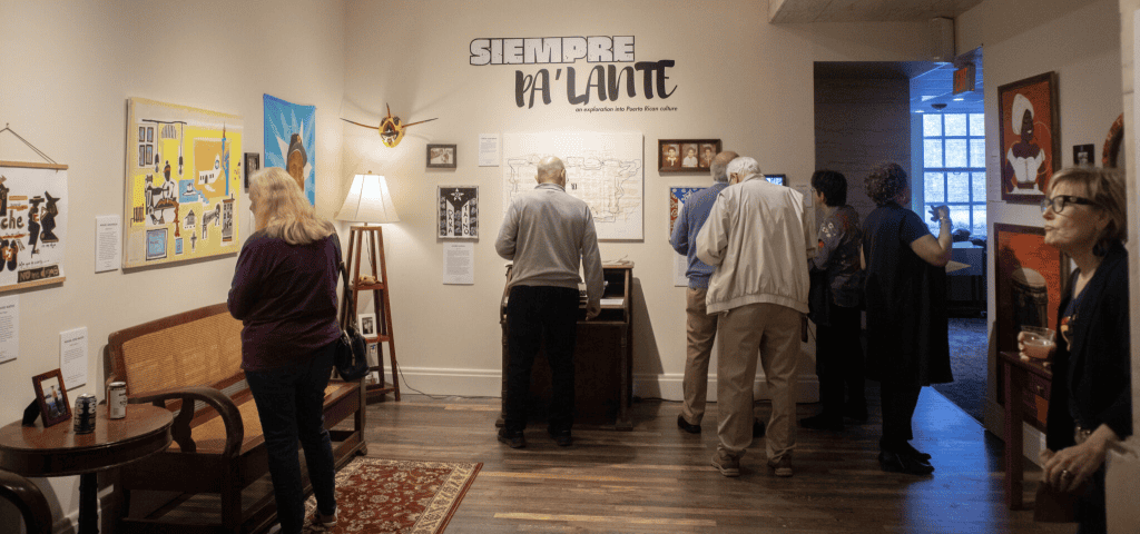 Visitors exploring Puerto Rican heritage exhibit at Siempre Pa’Lante.