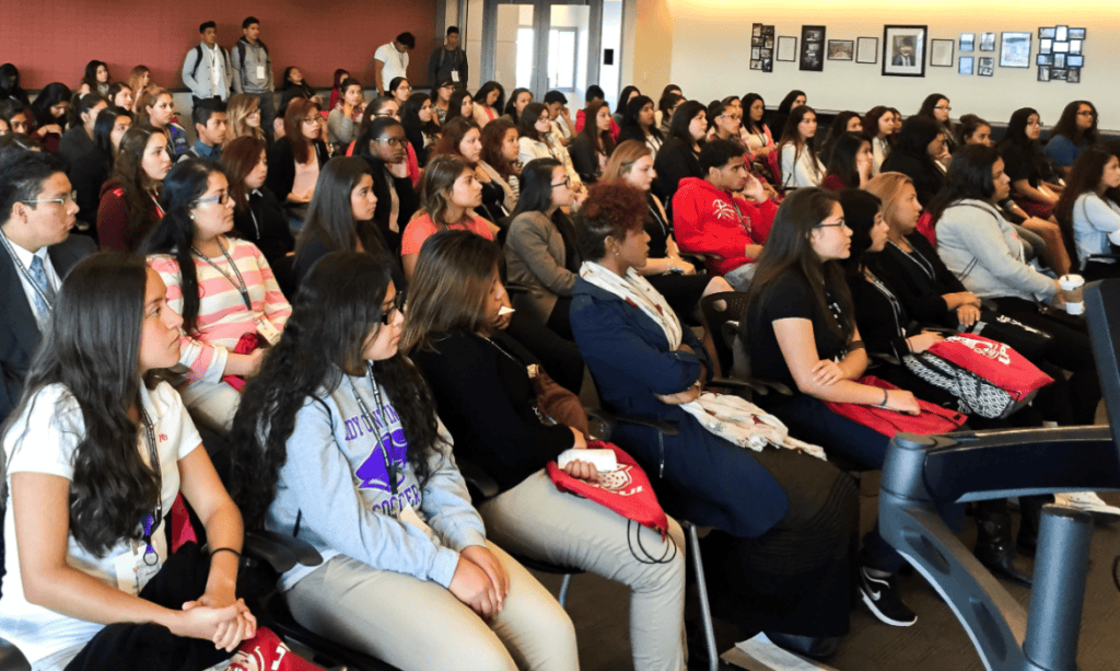 Diverse Latino students attending an educational workshop on student success and advocacy.