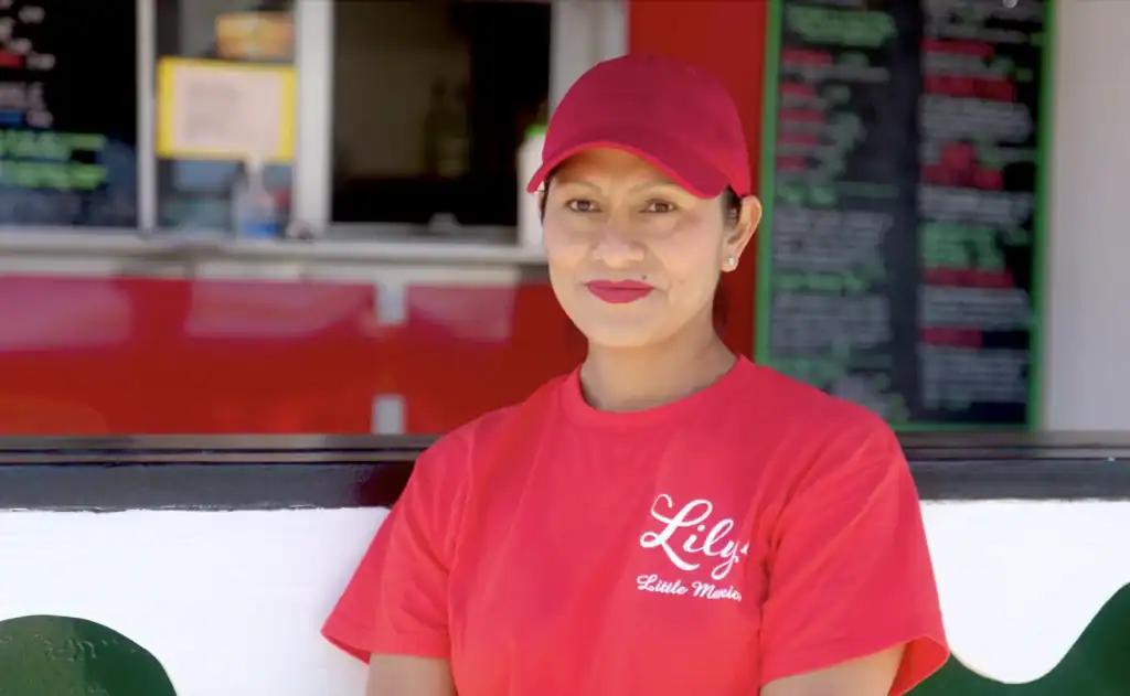 Friendly Latina woman working at Lily's Lemonade stand on the Eastern Shore.