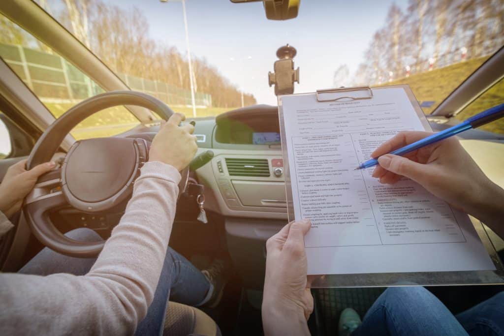 COVID-19 vaccination card and driver’s license application inside a car.