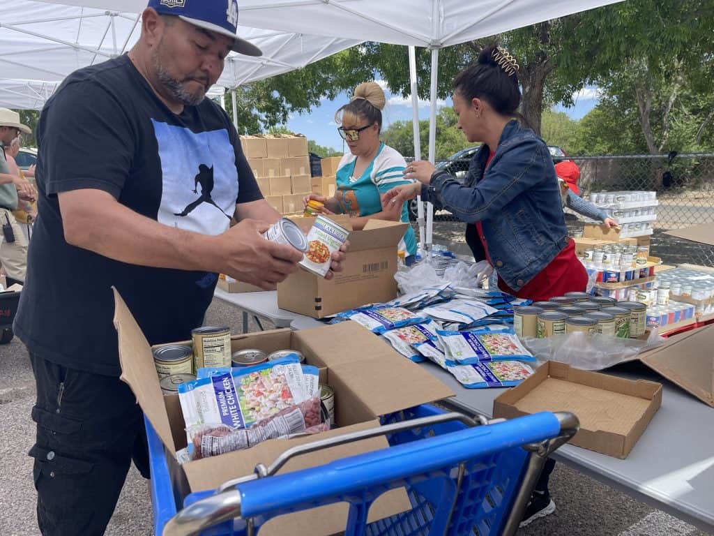 Volunteers distributing food supplies at a community event in rural New Mexico.