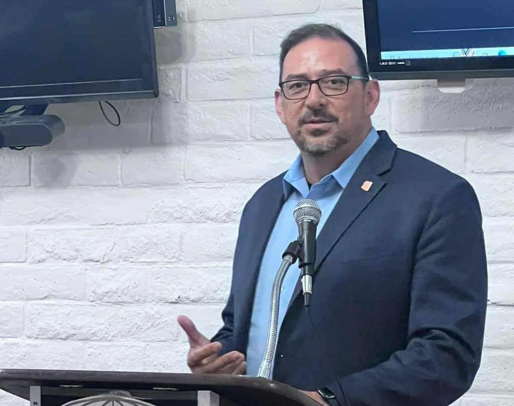 Adrian Fontes speaking at a public event about democracy and civic engagement.
