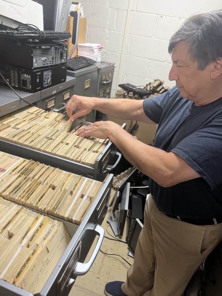NYC official inspecting lead service line records for replacement efforts.
