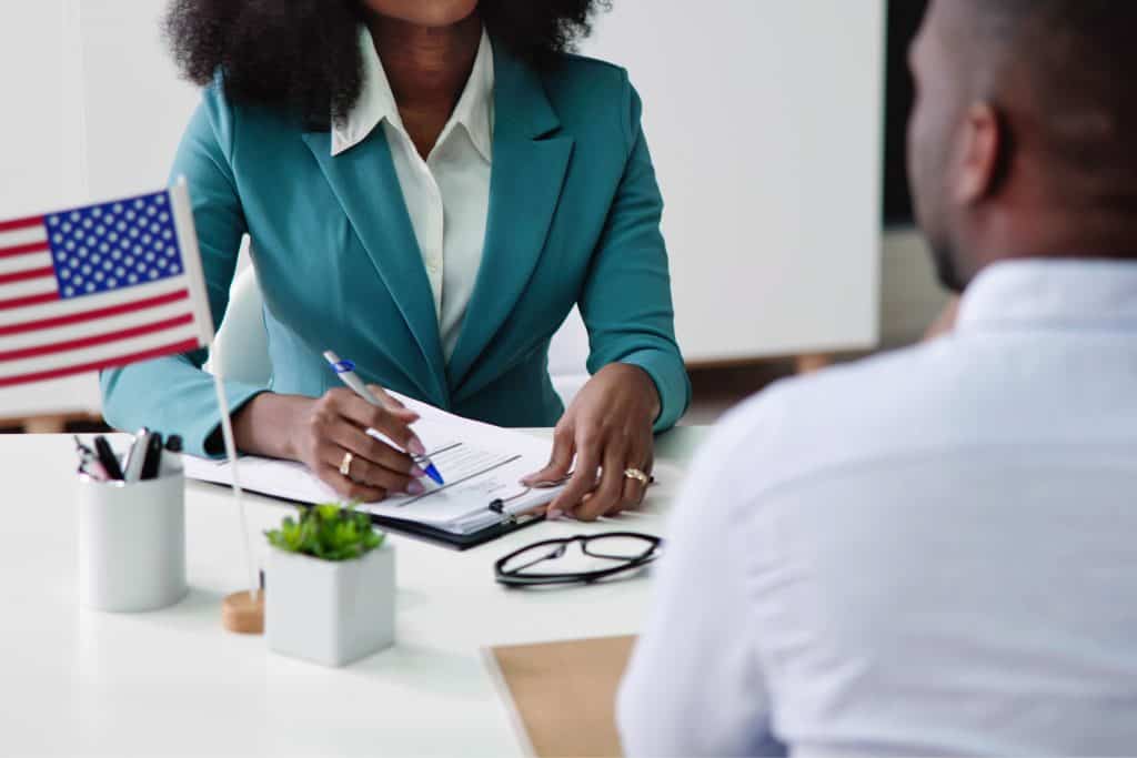US immigration interview with official discussing work permits and immigration policies.