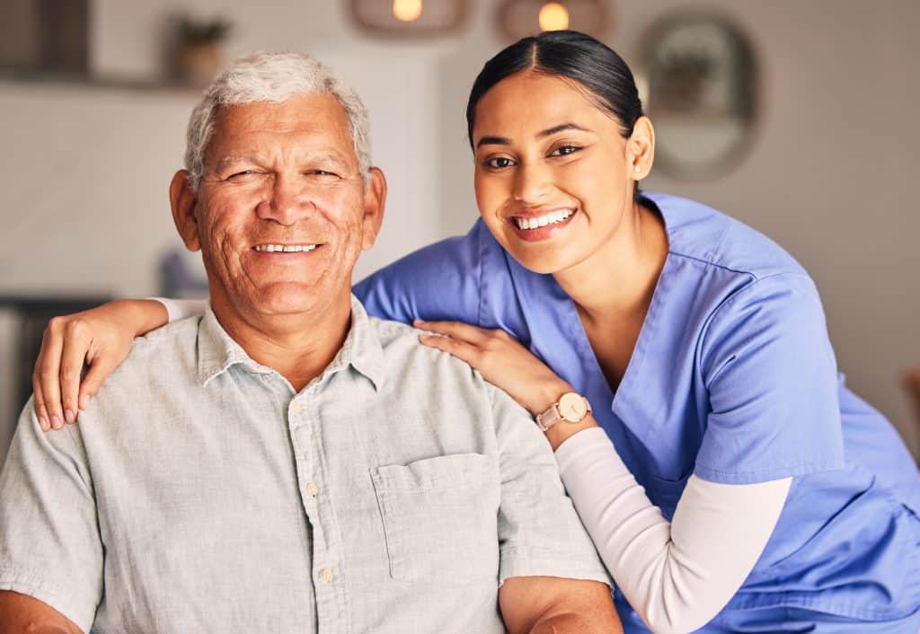 Bilingual healthcare worker with senior patient in a supportive setting.