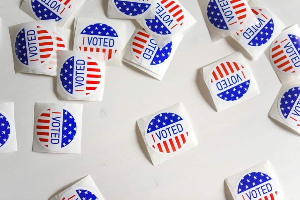 Latino voter stickers with patriotic design for election participation.