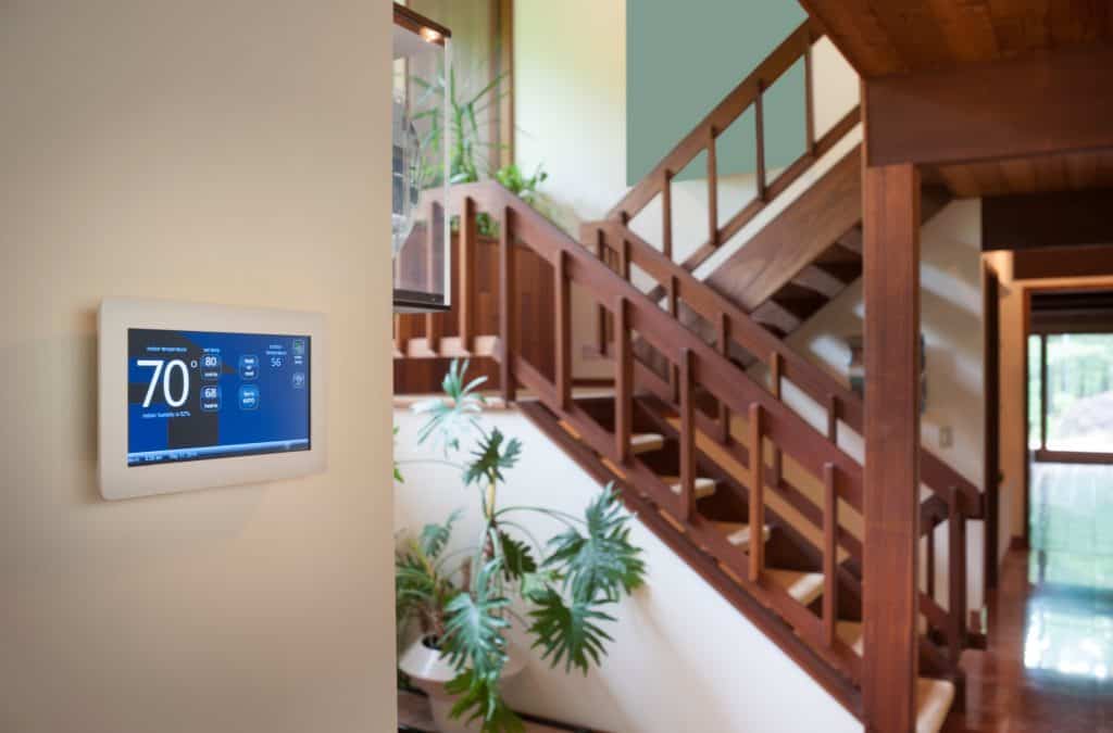 Energy-efficient smart thermostat controlling home climate in a modern interior.