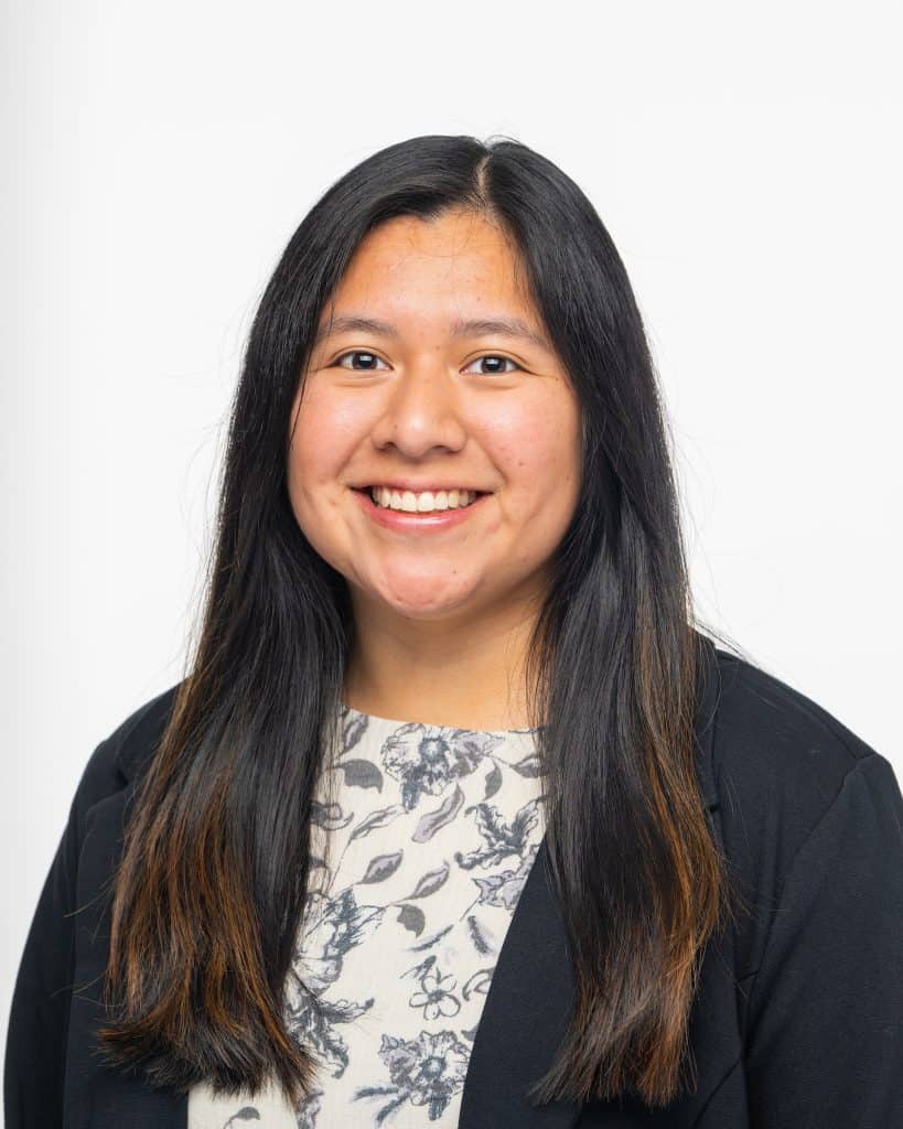 Tennessee Tech recruitment specialist smiling, honoring immigrant family achievements.