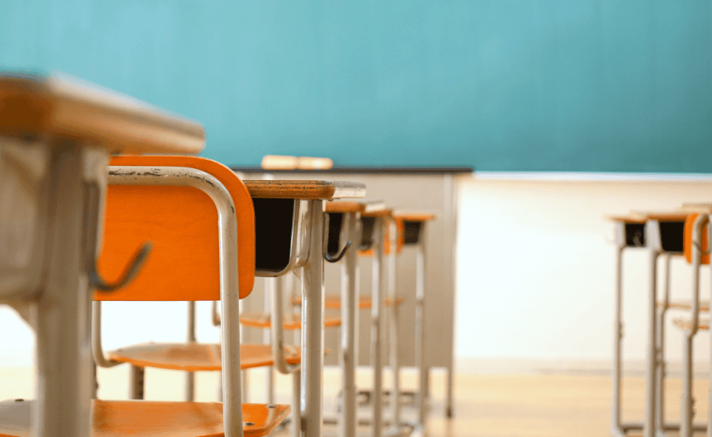 School classroom with empty desks and chairs, preparing for potential immigration investigations.