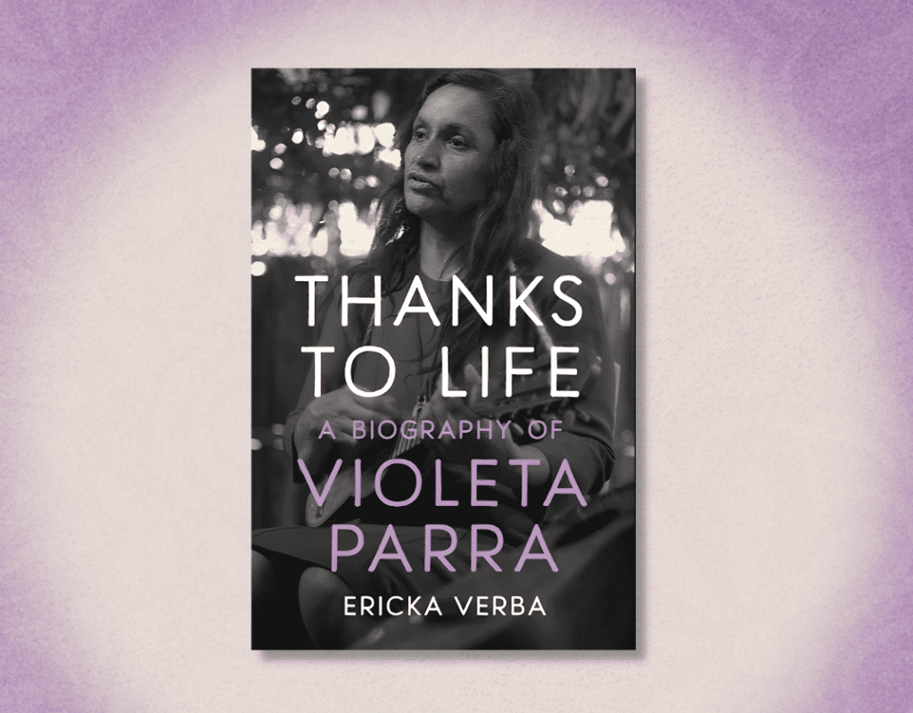 A woman holding a book titled "Thanks to Life" by Violeta Parra, author Ericka Verba, outdoors with.
