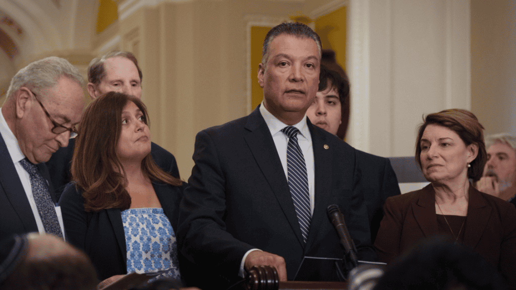 Senior Latino leader speaking at press conference about transformational leadership.