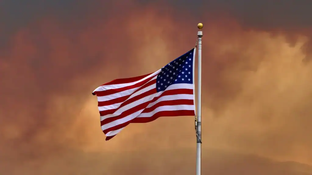 American flag waving at sunset, symbolizing democracy and national pride.