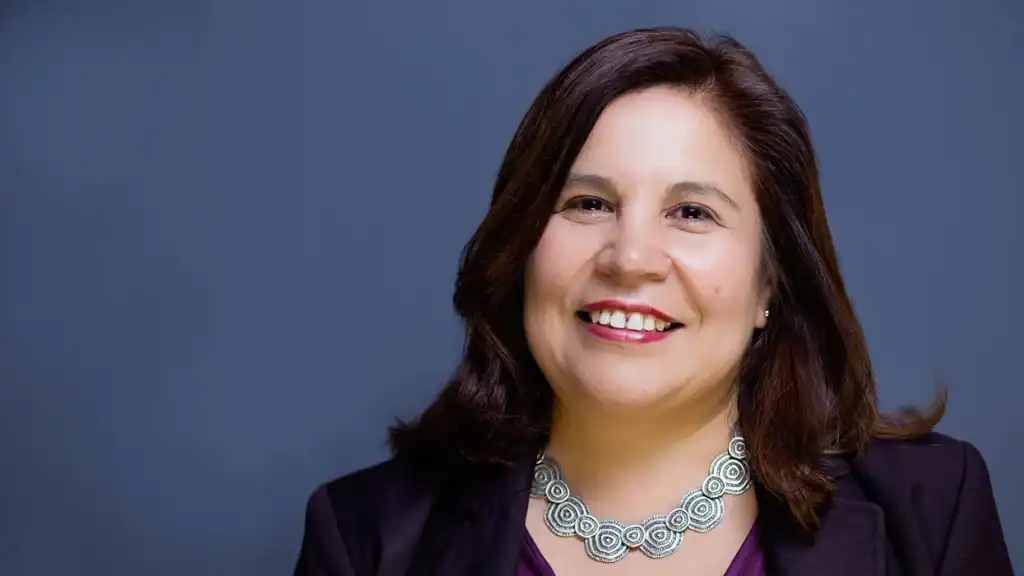 Angelica Salas smiling, representing resilience and leadership in immigrant communities.