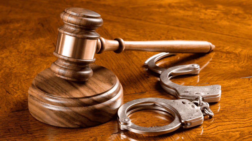 Gavel and handcuffs on wooden table representing legal reforms affecting youth policing.