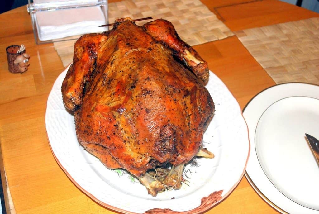 Roast turkey for Thanksgiving dinner on a wooden table.
