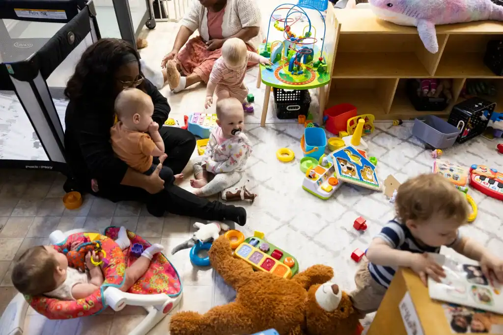 Preschool children playing with toys in a daycare setting, highlighting early childhood care and edu.
