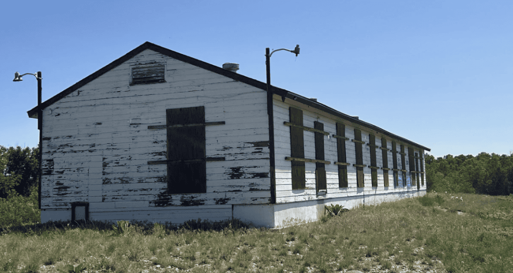 Abandoned historic building with boarded windows, symbolizing neglected Latino heritage and efforts.