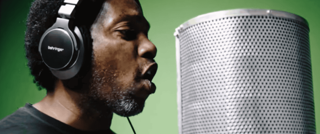 A man recording vocals with a microphone, emphasizing storytelling through music.