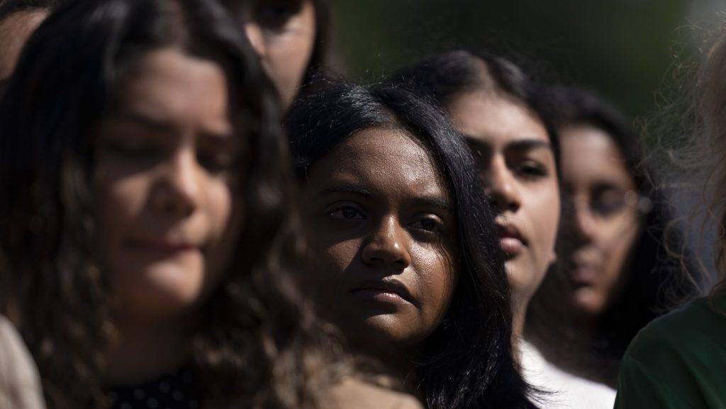 Group of diverse young women outdoors, representing Latino youth and community.