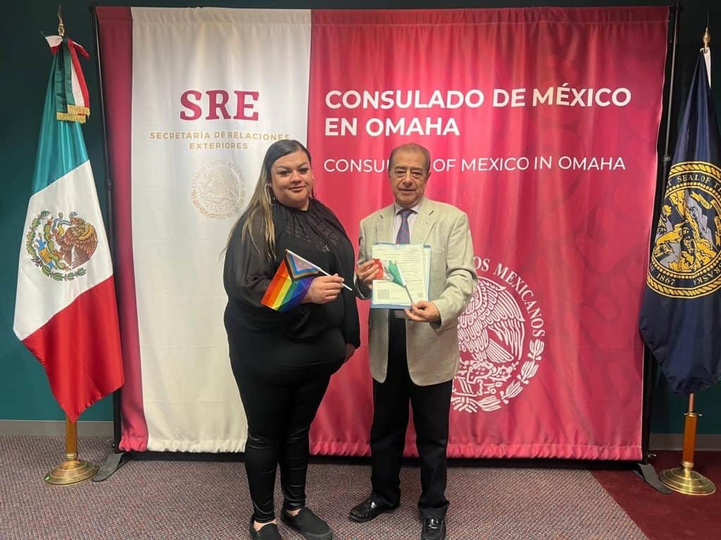 Mexican consulate official awards certificate to woman at event in Omaha.