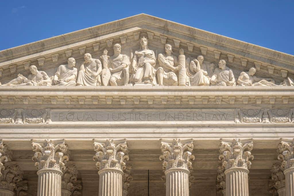 Close-up of the U.S. Supreme Court building with classical columns and sculptures.