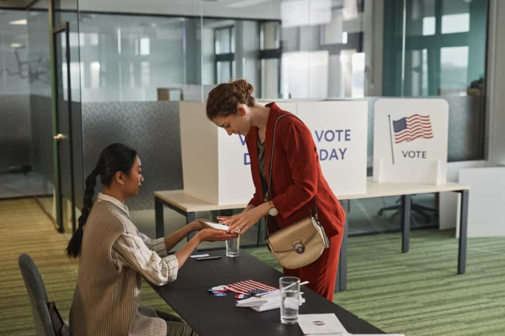 Woman registering to vote at polling station during election day.