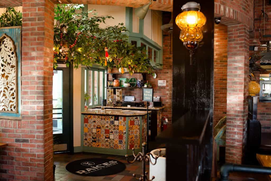 Interior of Mexican restaurant with brick walls and colorful decor.