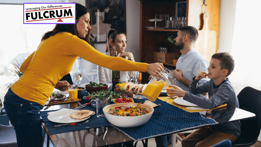 Family enjoying breakfast together at a dining table with food and drinks.