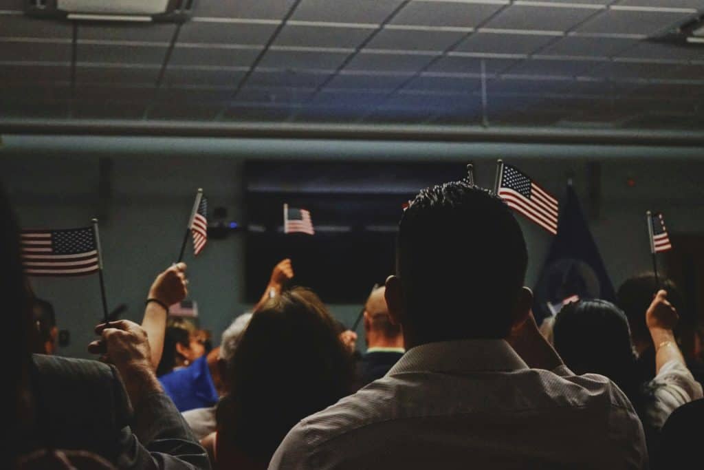 People holding American flags at a Latino News Network event.